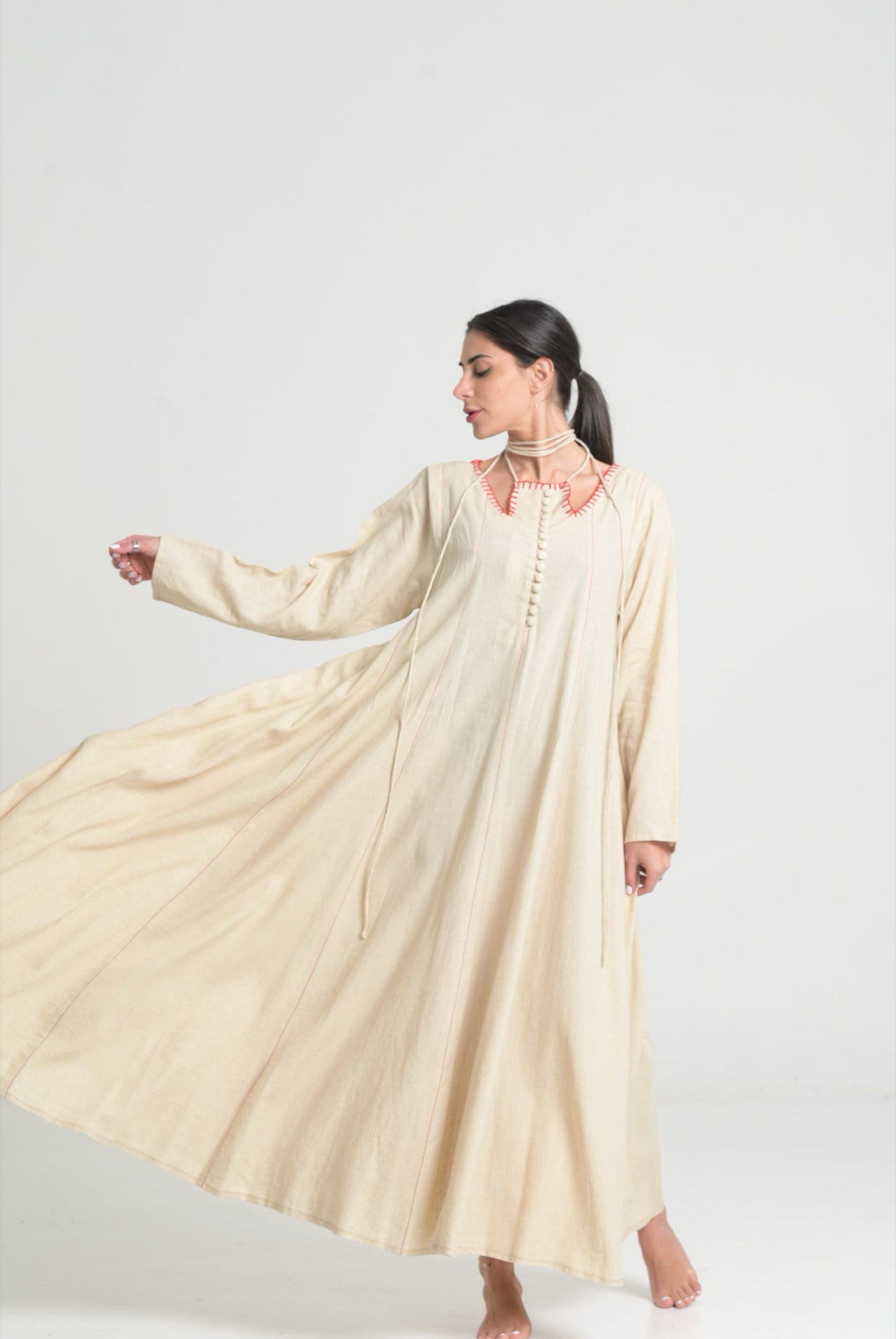 Beige dress with red stitching